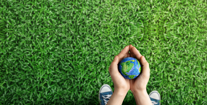 Niño que sostiene globo terráqueo en sus manos