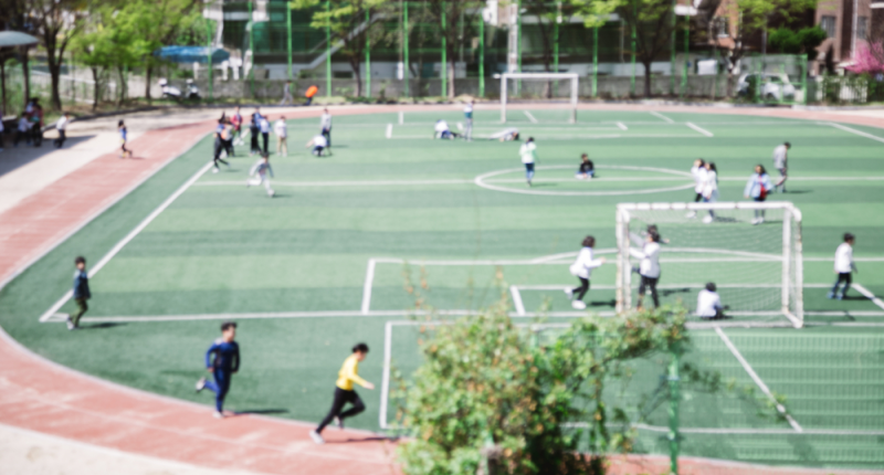 Grupo de niños practicando educación física a lo lejos