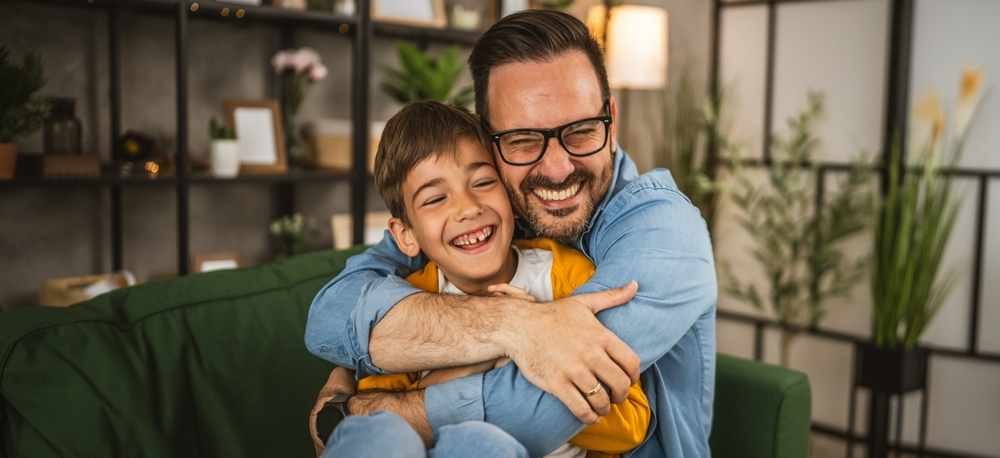 Padre abraza afectuosamente a su hijo de primaria